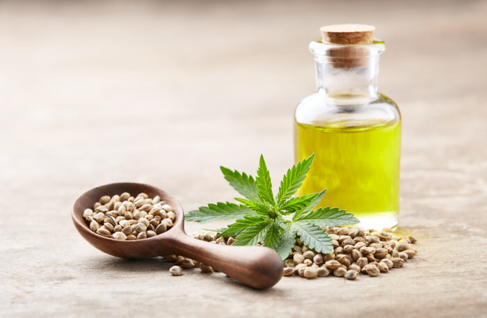 Hemp oil with seeds and cannabis plant