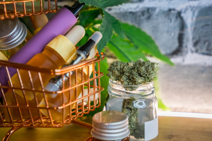 Mini shopping cart with various Medical Cannabis products on table, Shopping purchase concept